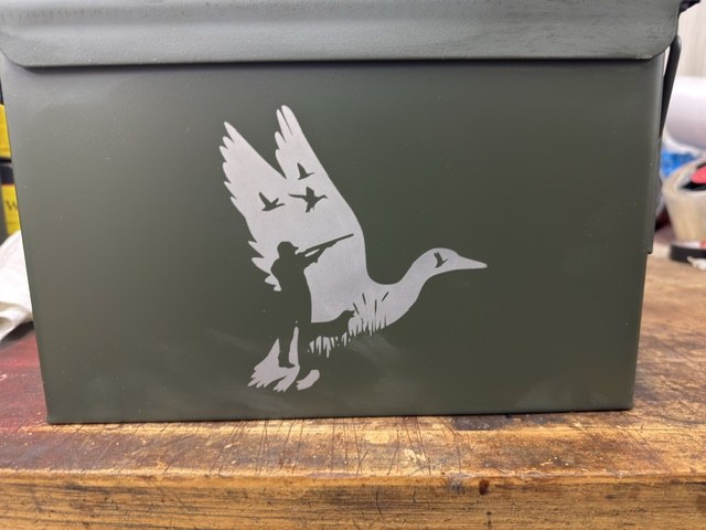 Custom ammo can engraved with a flying duck hunting scene